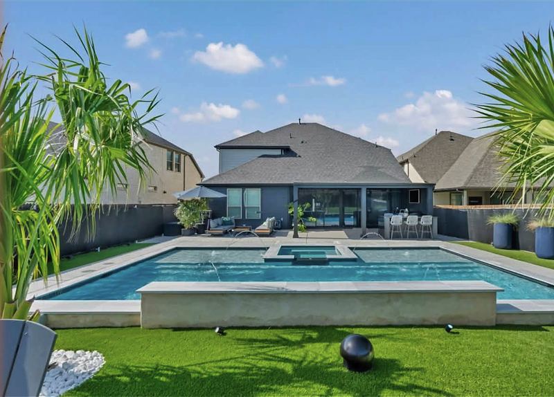 Pool and raised spa with turf surround