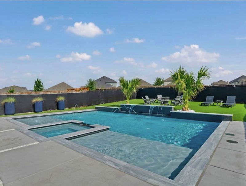 Geometric gunite pool with a tanning ledge and attached spa
