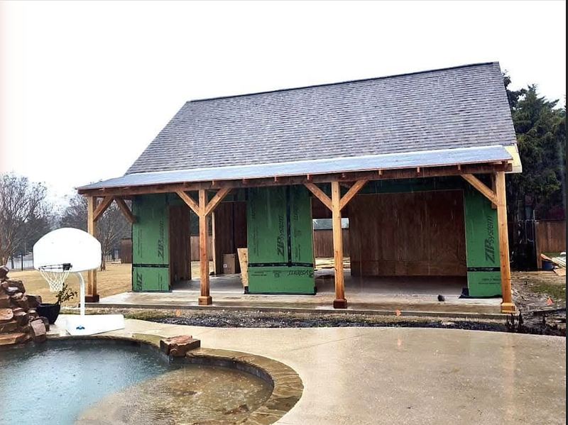 Pool house framed beside a finished spa